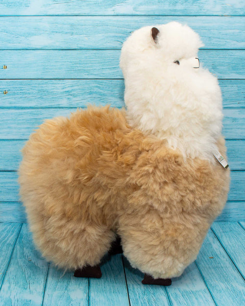 Soft alpaca fur stuffed animal. Beige and white, 18 inches. Lateral view