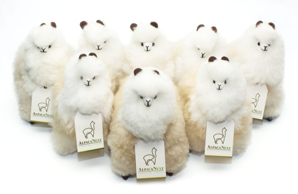 Group of the AlpacaNext 9 inch beige and white alpaca figure showing the natural fur texture.