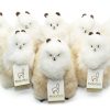 Group of the AlpacaNext 9 inch beige and white alpaca figure showing the natural fur texture.