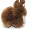Side profile of the AlpacaNext 9 inch brown alpaca plush showcasing elite artisan craftsmanship