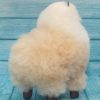 Soft alpaca stuffed animal. Beige and white, 9 inches. Back view